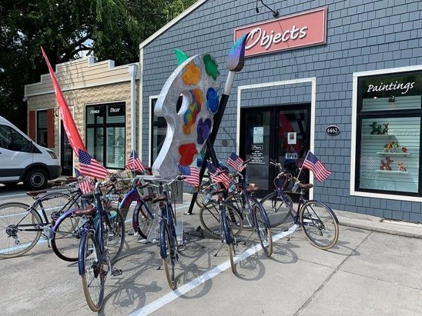 Art gallery storefront with bicycles and community art